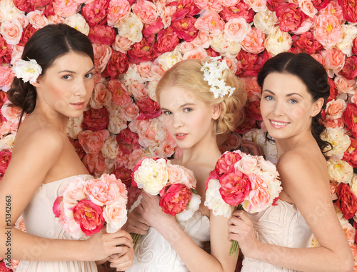 Photo: three women with background full of roses three women with background full of roses