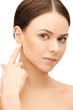 woman touching her ear