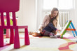 Mother and daughter drawing in the room