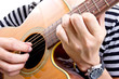 Guiter player picking music in studio