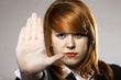 Young woman making stop gesture sign