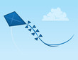 Blue kite flying through the open sky