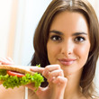 Happy smiling woman with sandwich at home