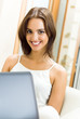 Cheerfull smiling woman working with laptop
