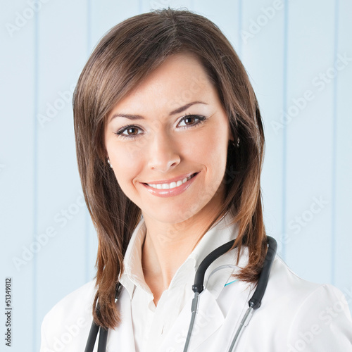 Photo: Cheerful female doctor at office Cheerful female doctor at office