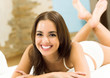 Young woman waking up on bed