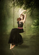 The girl on the swing in the woods above the water