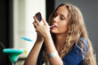 Photo: Beautiful woman applying a lipstick Beautiful woman applying a lipstick