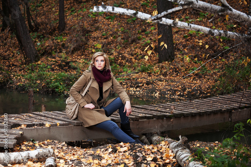 Photo: Young blond woman in autumn forest Young blond woman in autumn forest