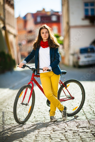 Photo: Urban biking - teenage girl and bike in city Urban biking - teenage girl and bike in city