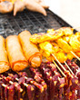 Foto: Traditional Thai food at market. Dry beef meat, spring rolls Traditional Thai food at market. Dry beef meat, spring rolls