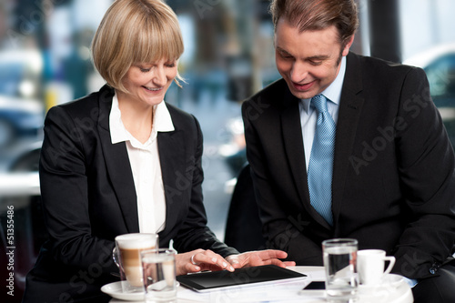 Photo: Corporates discussing business over a coffee Corporates discussing business over a coffee