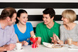 Happy family of four in restaurant