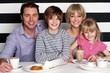 Family of four having great time in restaurant