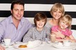 Family enjoying breakfast at restaurant