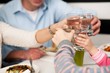 Family toasting water glasses in celebration