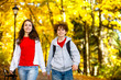Girl and boy walking in city park
