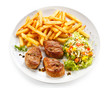 Grilled steaks, French fries and vegetables