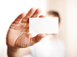 Human hand holding blank business card with copy space, small do