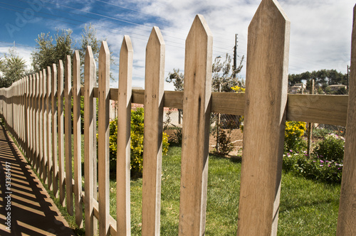 Photo: wooden fence and blue sky background wooden fence and blue sky background