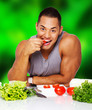 sexy guy is eating tomatoe