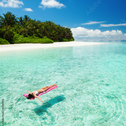 Photo: Woman relaxing on inflatable mattress in the sea Woman relaxing on inflatable mattress in the sea