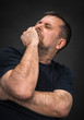 Headache. Man with face closed by hand
