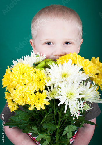 Photo: Boy holding a bunch of flowers Boy holding a bunch of flowers