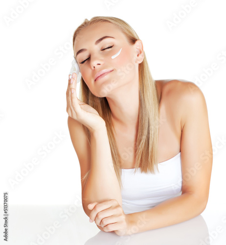 Photo: Beautiful female using moisturizer Beautiful female using moisturizer