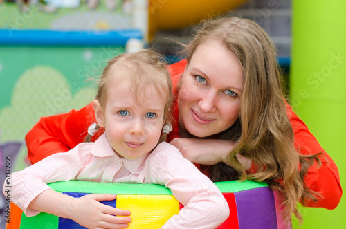 Photo: Portrait of woman and little girl in playroom Portrait of woman and little girl in playroom