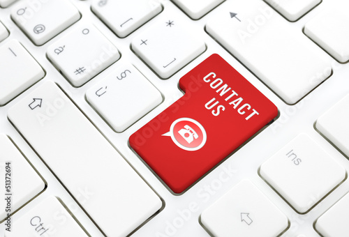 Photo: Contact us business concept, red key on white keyboard Contact us business concept, red key on white keyboard