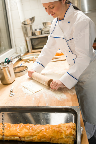 Photo: Smiling female baker rolling dough rolling pin Smiling female baker rolling dough rolling pin
