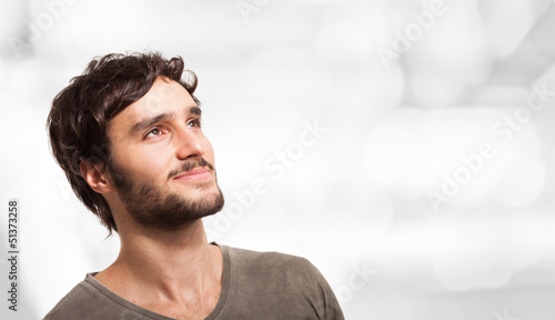 Photo: Smiling young man looking up Smiling young man looking up