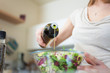 Photo: Woman dressing a salad Woman dressing a salad