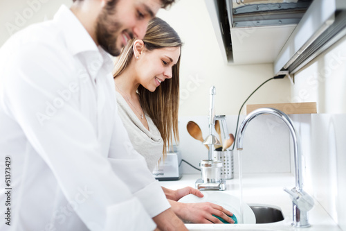 Photo: Young couple doing dishes Young couple doing dishes