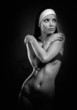 Sexy young nun posing indoors, black and white photo