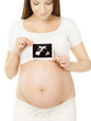 Pregnant woman holding ultrasound scan photo of baby over belly,