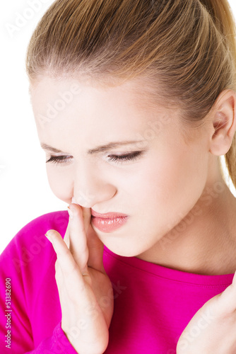 Photo: Teen woman having a terrible tooth ache. Teen woman having a terrible tooth ache.