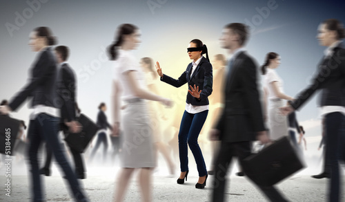 Photo: Businesswoman in blindfold among group of people Businesswoman in blindfold among group of people