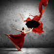 Ballet dancer in flying satin dress with umbrella
