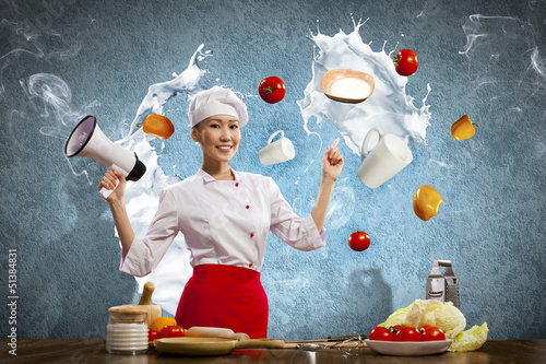 Photo: Asian female cook holding megaphone Asian female cook holding megaphone