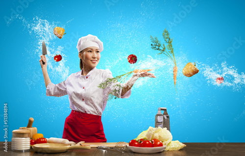 Photo: Asian female cook with knife Asian female cook with knife