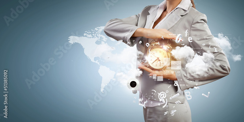 Photo: Business man holding alarmclock Business man holding alarmclock