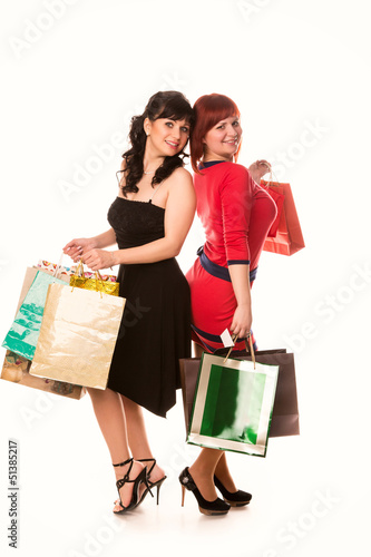 Photo: Beautiful happy girls with many shopping bags. Shopping concept. Beautiful happy girls with many shopping bags. Shopping concept.