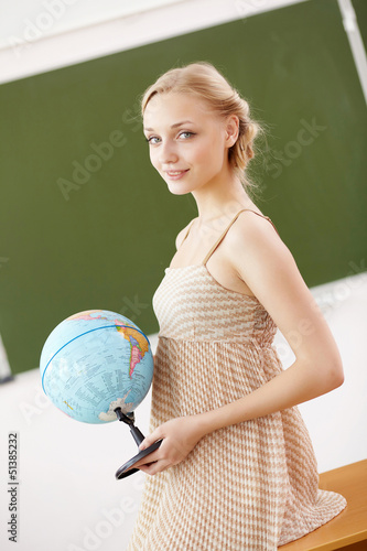 Photo: Teacher at school with a globe Teacher at school with a globe
