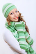 Photo: Young woman wearing winter hat and warm scarf Young woman wearing winter hat and warm scarf