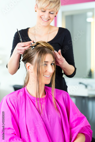 Photo: Woman receiving haircut from hair stylist or hairdresser Woman receiving haircut from hair stylist or hairdresser