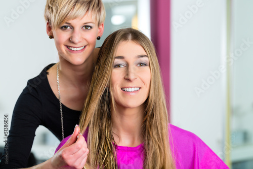 Photo: Woman at the hairdresser getting advise Woman at the hairdresser getting advise