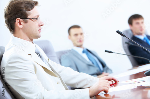 Photo: Three businesspeople at meeting Three businesspeople at meeting