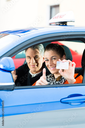 Photo: Young woman at driving lesson Young woman at driving lesson